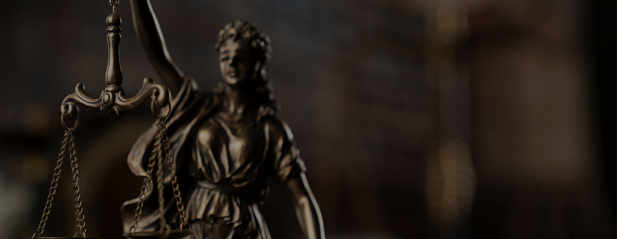 Bronze Lady Justice statue holding balanced scales